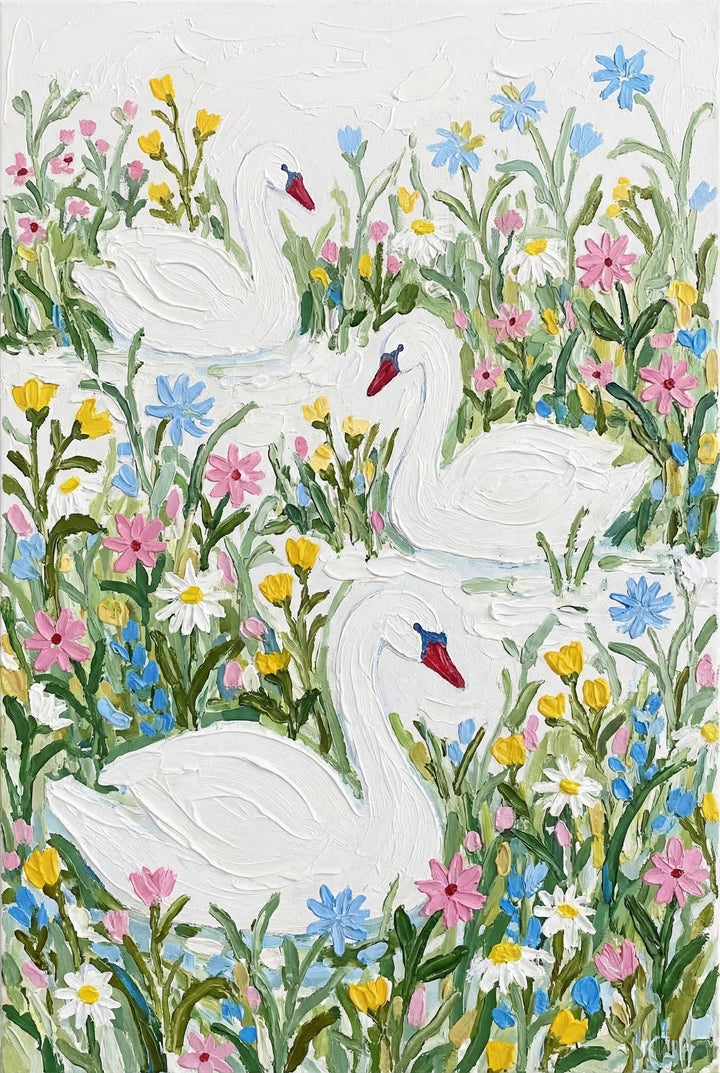 Close up of a textured painting showing three white swans gliding through shallow water surrounded by colorful wildflowers in pink, yellow, blue, and white. Thick brushstrokes and soft pastel tones create a dreamy, storybook feel with the swans gently reflected in the water.