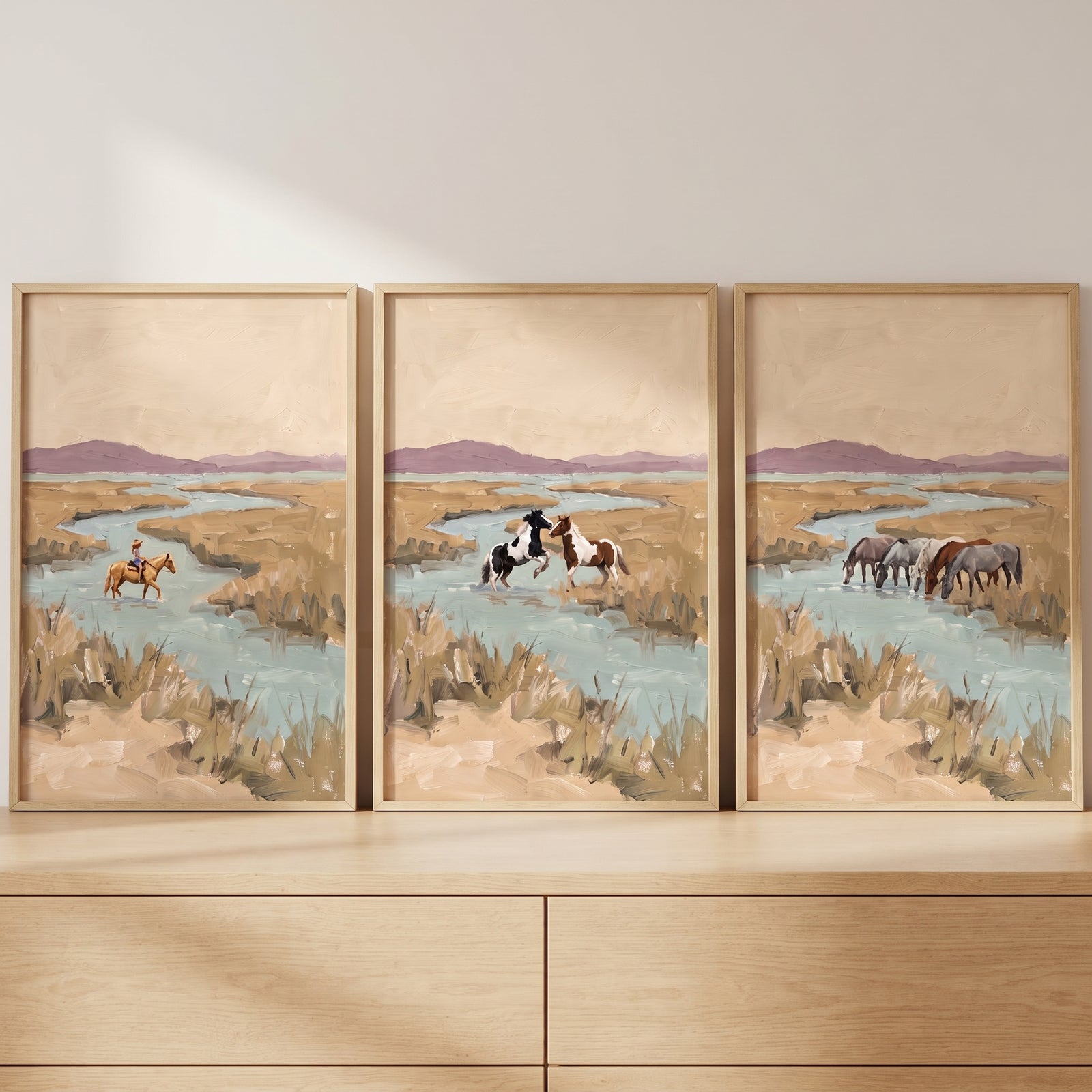 Textured tan marshland horses wall art set of 3 shows horses and a rider by a river in light wood frames.