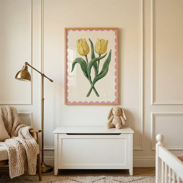 Soft and cozy nursery corner with a white storage bench, plush bunny toy, and a chair draped with a chunky knit blanket beside a floor lamp. Above the bench hangs a framed painting of two yellow tulips with green leaves and a pink scalloped border, adding a gentle and cheerful floral touch to the space.