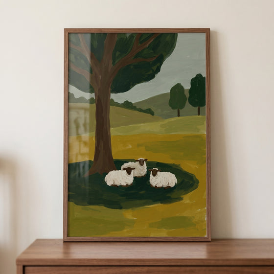 Three sitting woolly sheep wall art depicts a pastoral scene with a large tree and rolling green hills.