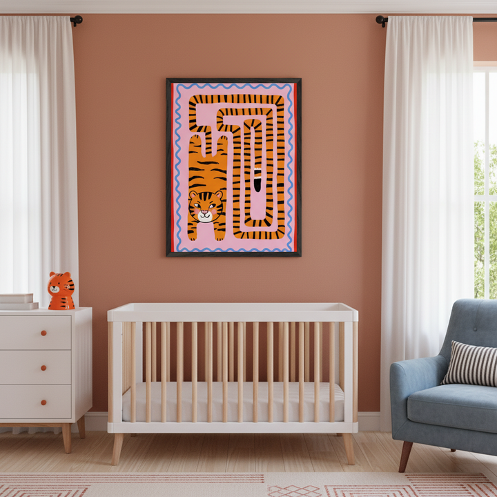 Modern nursery with white crib, dresser, and light blue armchair. A framed wall art depicting a cartoon tiger and an orange striped labyrinth on a pink background hangs above the crib on a terracotta wall.