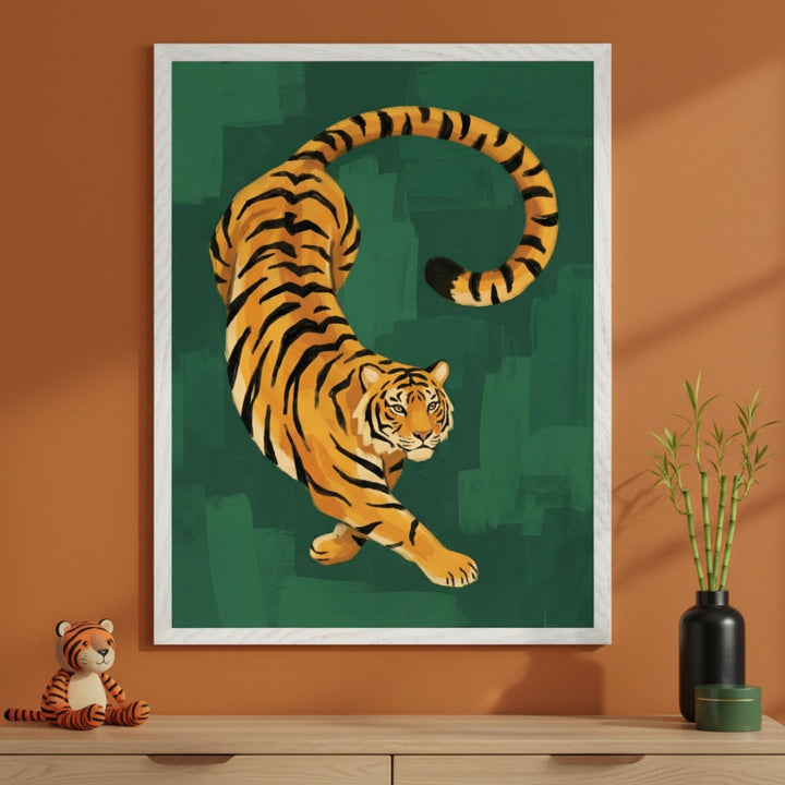 Modern room with a terracotta wall and a light wood dresser. A large framed print of a stylized orange tiger with black stripes against a dark green, brushstroke background hangs centered above the dresser. A stuffed tiger and bamboo in a black vase are on the dresser.