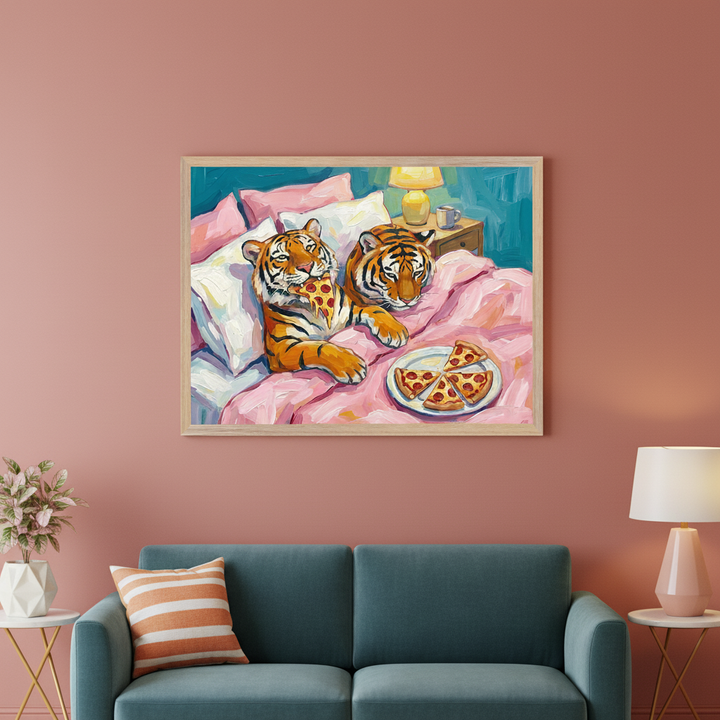 Modern living room with a dark teal sofa. A light wood-framed painting of two tigers on a pink bed eating pizza, in a painterly style, hangs centered above the sofa.