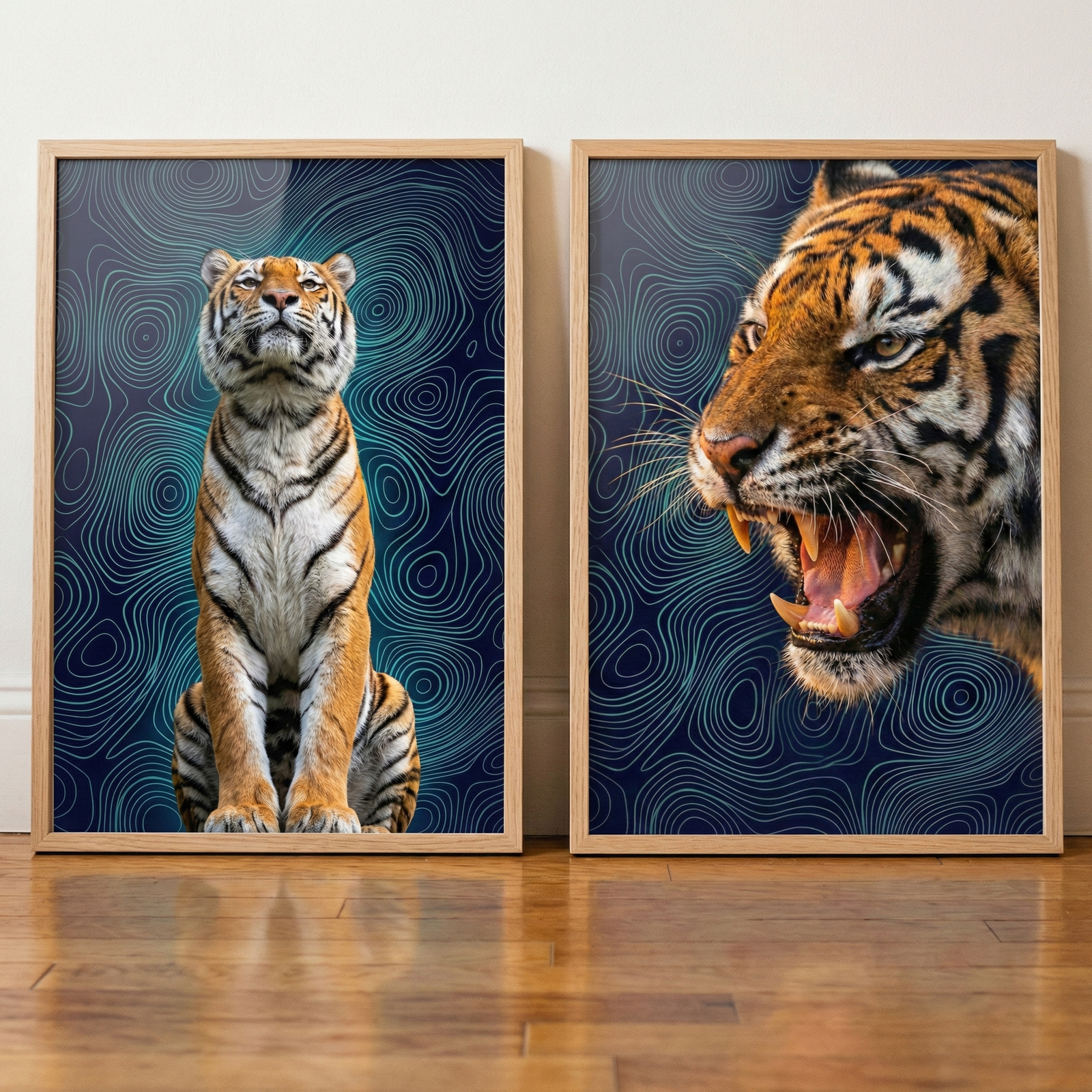 Two framed tiger portraits with a dark blue contour pattern background rest on a wooden floor against a wall. One shows a tiger sitting upright and looking upward while the other is a close view of a roaring tiger with its mouth open and teeth visible.