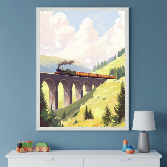 A green and orange steam engine pulls carriages over a towering arched bridge, surrounded by rolling hills and pine trees in a sunlit mountain landscape. The framed artwork captures the magic of rail journeys and pairs perfectly with train-themed toys below.