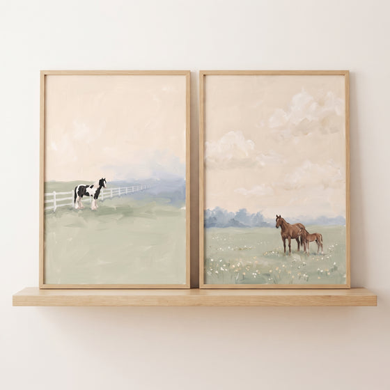 Tranquil peach sky horse wall art set of 2 on a wooden shelf, showing horses in soft green fields with a white fence.