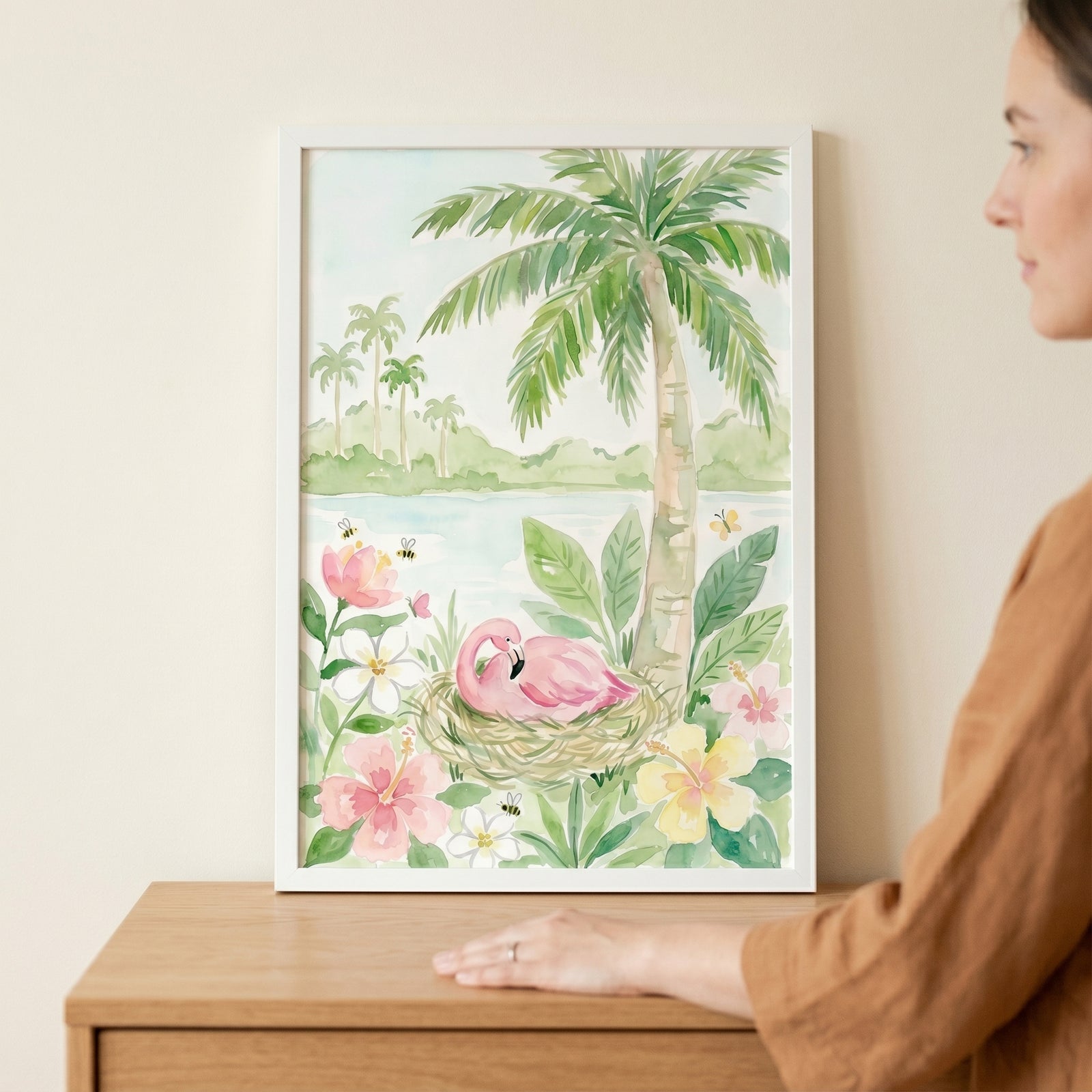 Tropical hibiscus pink flamingo wall art in a white frame shows a bird in a nest among palm trees and flowers.