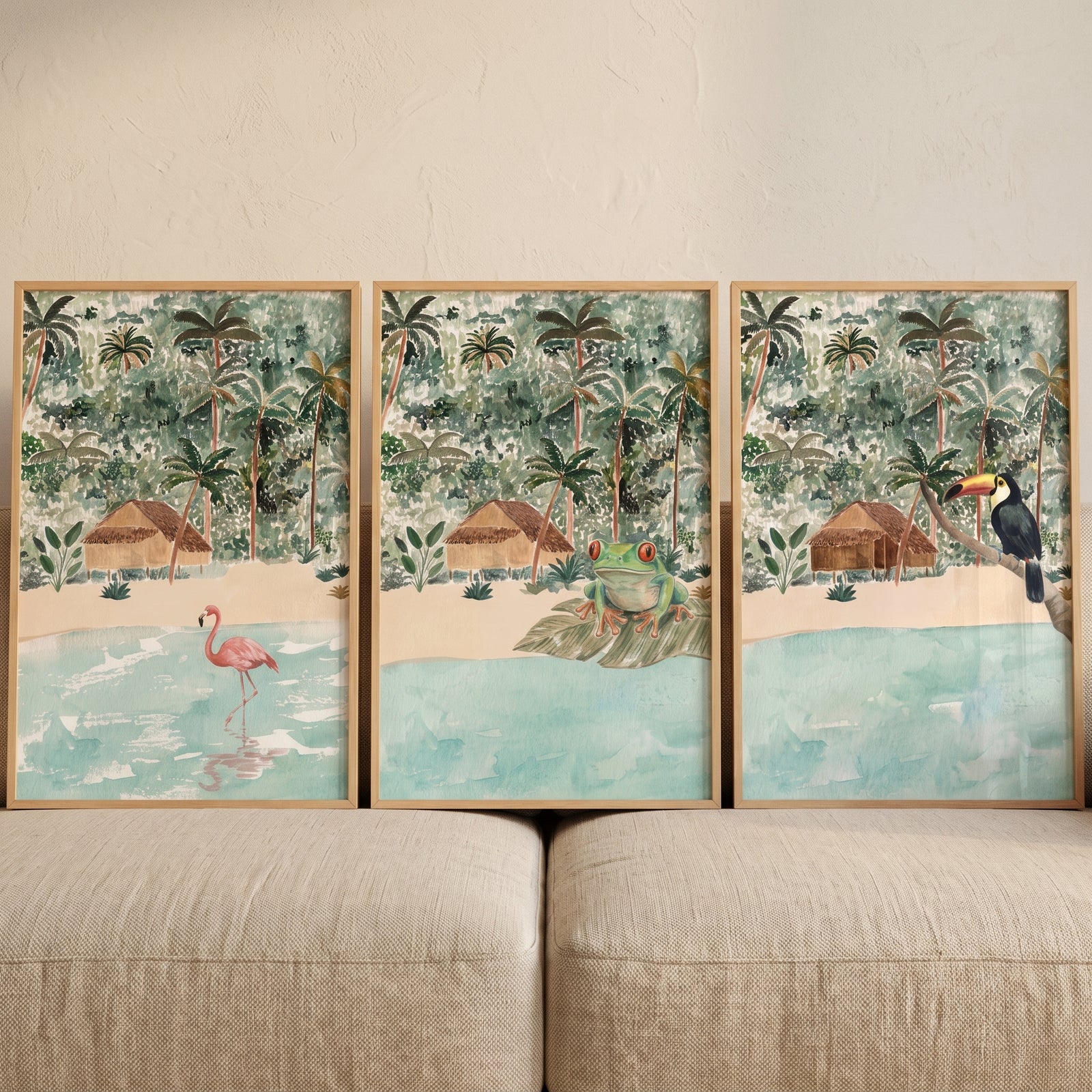 Tropical jungle beach hut animals wall art set of 3 with a pink flamingo, green frog, and toucan by the water.