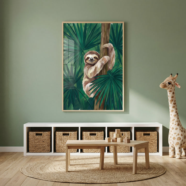 Children’s playroom with a soft green wall, wooden table, and woven storage baskets beneath a shelf unit, styled with a plush giraffe toy. A framed painting of a smiling sloth hugging a tree among lush tropical leaves hangs above, adding a calm and playful jungle theme to the space.