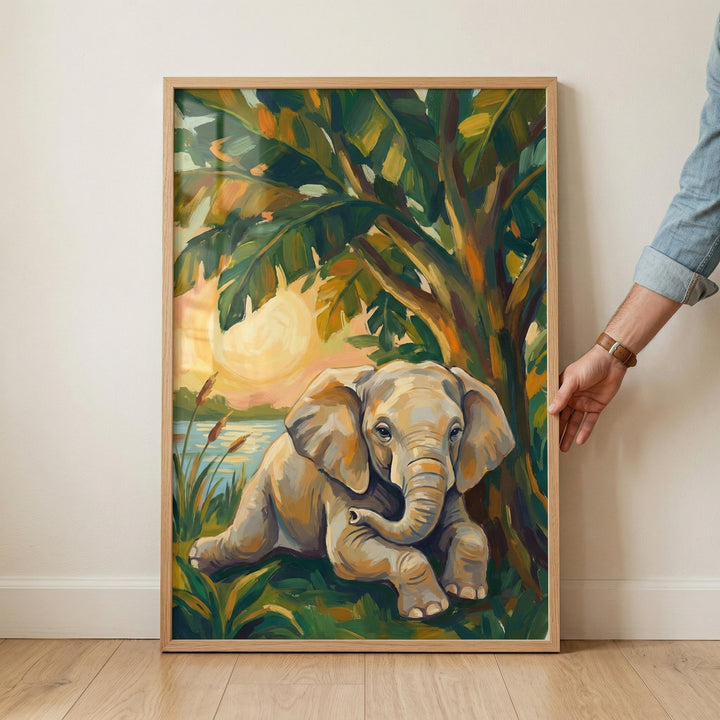 A vertical framed illustration captures a young elephant resting peacefully beneath the shade of a tropical tree with large, broad leaves. The artwork is characterized by bold, textured brushstrokes in a vibrant palette of emerald green, warm orange, and golden yellow. 