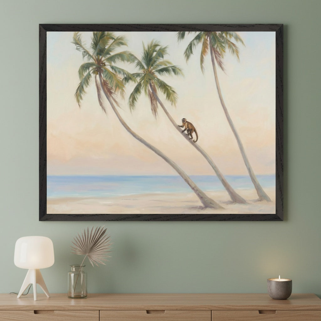 Modern room with a light wood dresser. A large black-framed painting of a tropical beach with three leaning palm trees, a monkey climbing, and an ocean view hangs above the dresser.