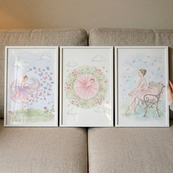 Tulle tutu ballerina wall art set of 3 featuring framed watercolor illustrations of dancers displayed on a grey couch.