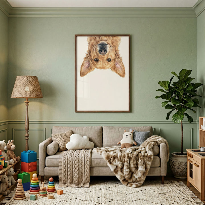 Upside down golden retriever wall art hangs above a beige sofa in a green room with toys and a potted plant.