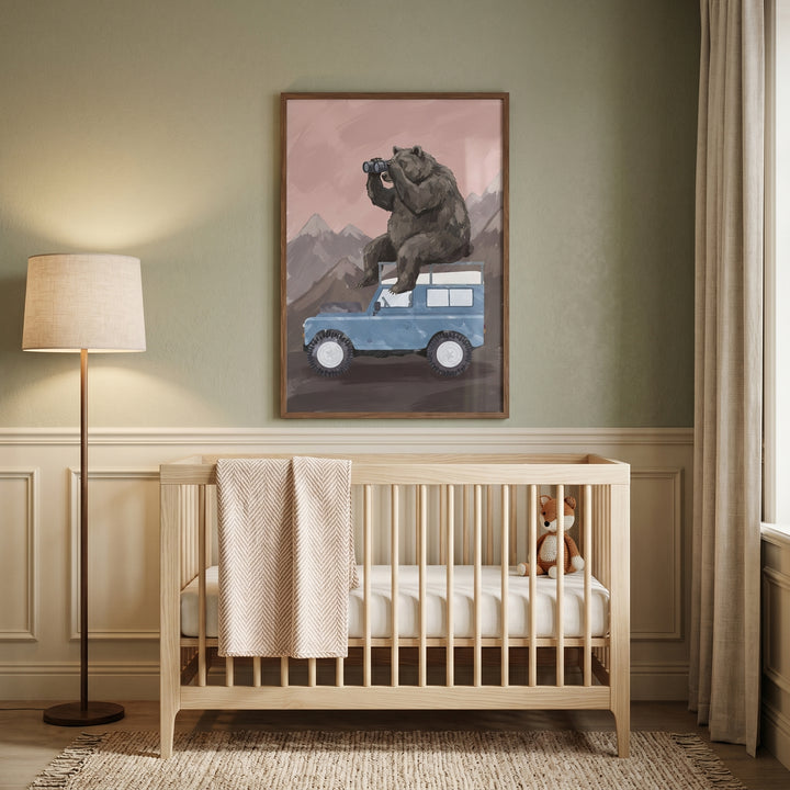 Wooden crib and lamp below using binoculars brown bear wall art of a bear on a blue off-road vehicle.