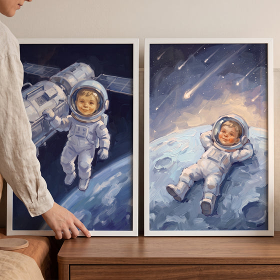 vibrant indigo toddler astronaut wall art set of 2 showing a child floating near a satellite and reclining on the moon.