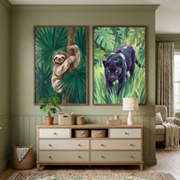 A cozy, sage-green room featuring two large framed jungle-themed illustrations above a wooden dresser. One illustration shows a light brown sloth climbing a tree trunk amidst lush green leaves, while the other depicts a black panther with yellow eyes walking through dense foliage. Below them sits a light-wood dresser with eight drawers in shades of off-white and muted green. The scene includes a small potted plant, woven baskets, a lamp, a large floor basket, and a patterned rug.