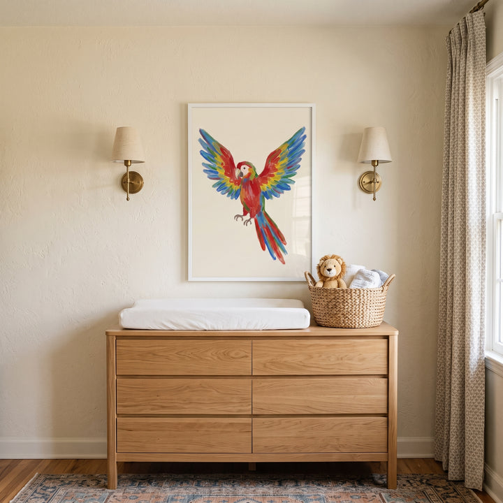 Vibrant wings spread macaw bird wall art hangs above a wooden dresser with a changing pad between two wall sconces.