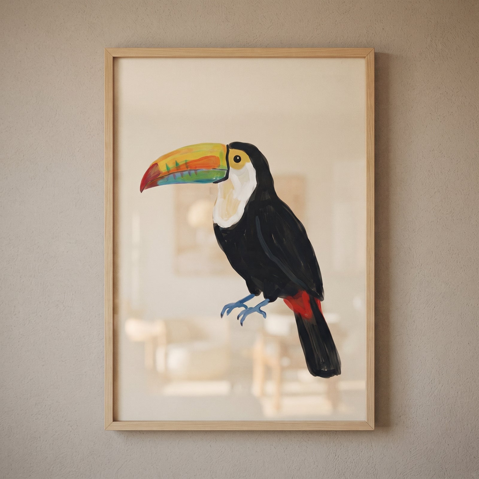 Vibrant yellow beak toucan bird wall art with blue feet and red tail in a wood frame on a neutral wall.