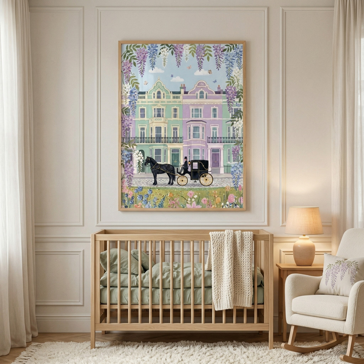 A softly styled nursery with a wooden crib and neutral decor featuring a framed illustration of pastel townhouses with a horse drawn carriage and floral details hanging above the crib.