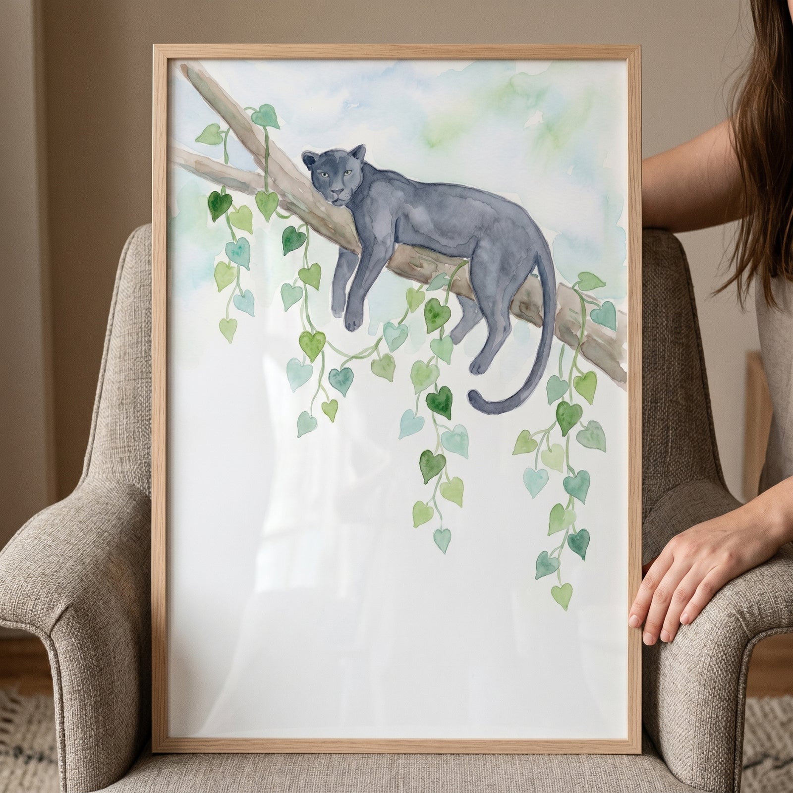 Framed vine jungle panther wall art showing a panther on a tree branch with hanging green heart-shaped leaves.