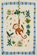 A charming illustration of a smiling brown cartoon monkey swinging from a green leafy vine. The central character is surrounded by an assortment of tropical foliage in different shades of green, along with small, scattered pink and orange flowers and star-like shapes. The entire scene is set against a pale cream background and is enclosed within a rectangular border featuring alternating light blue and dark green stripes. The art style is playful and soft.