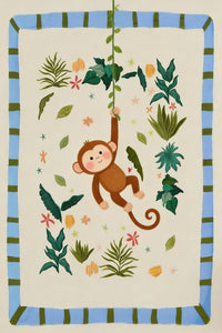 A charming illustration of a smiling brown cartoon monkey swinging from a green leafy vine. The central character is surrounded by an assortment of tropical foliage in different shades of green, along with small, scattered pink and orange flowers and star-like shapes. The entire scene is set against a pale cream background and is enclosed within a rectangular border featuring alternating light blue and dark green stripes. The art style is playful and soft.