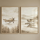 Two framed watercolor-style illustrations are mounted side-by-side on a tan wall. The left illustration features a vintage propeller airplane soaring above a dense coniferous forest under soft, hazy clouds. The right illustration shows a vintage floatplane on a calm lake, casting a clear reflection, with misty forest-covered mountains in the background. Both pieces use a monochromatic sepia color palette and are encased in thin, light-colored wood frames.