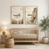 A peaceful nursery in neutral tones features a light wooden crib. Above it are two framed watercolor-style illustrations in sepia. One shows a vintage propeller plane over a pine forest, while the other depicts an aircraft flying past a rocky cliff. To the left is a small side table with a wooden lamp and a woven basket on the floor. To the right, a green plant sits in a large ceramic pot. A light-colored rug completes the warm and minimalist space.