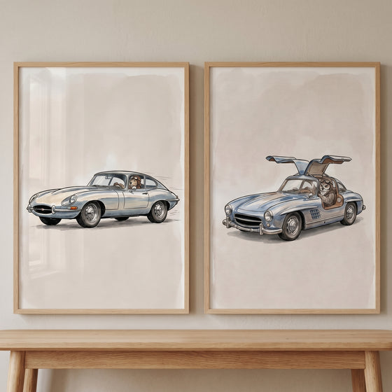 Vintage aviator driving animal wall art set of 2 featuring a dog and cat in silver classic sports cars.