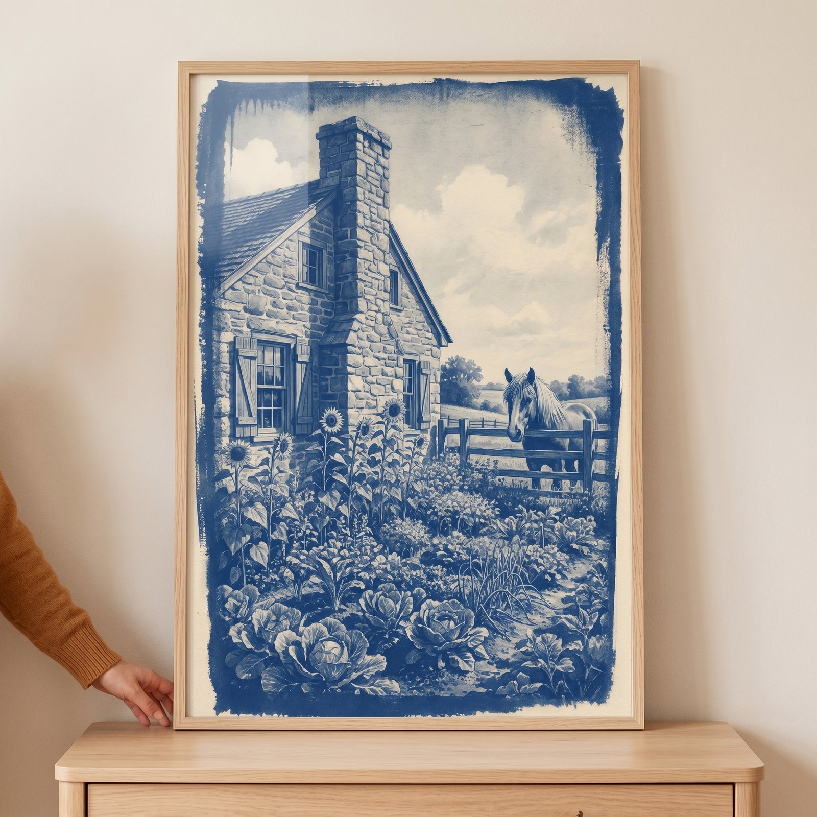Vintage blue farm horse wall art shows a stone house with a vegetable garden and a horse standing behind a fence.