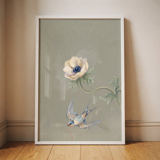 Vintage blue swallow floral wall art with a white anemone and bird in flight against a muted sage green background.