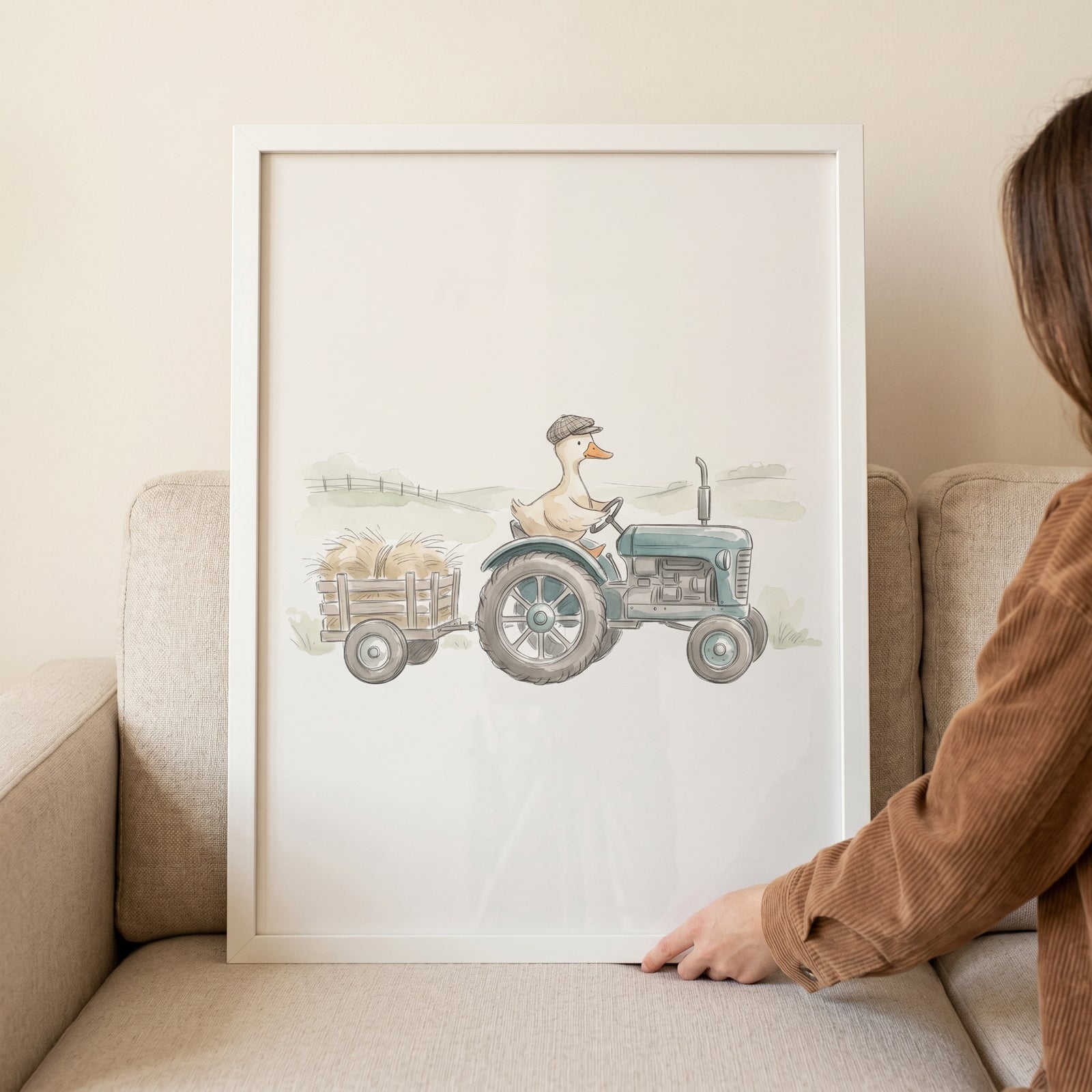 Framed vintage blue tractor duck wall art featuring a duck in a flat cap driving a tractor with a trailer of hay.