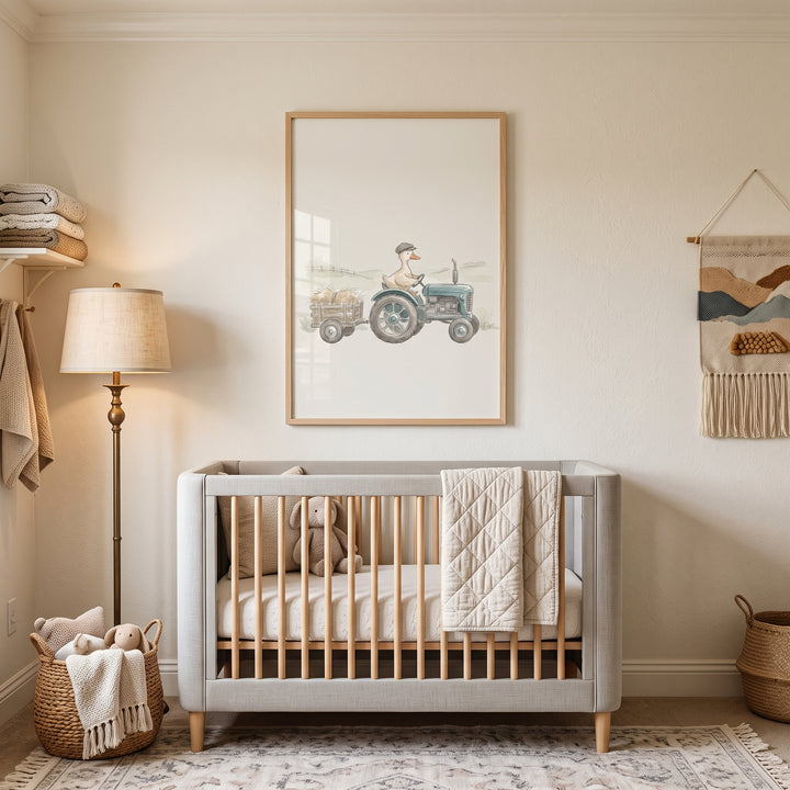 Neutral nursery with a grey crib and vintage blue tractor duck wall art hanging on the wall.