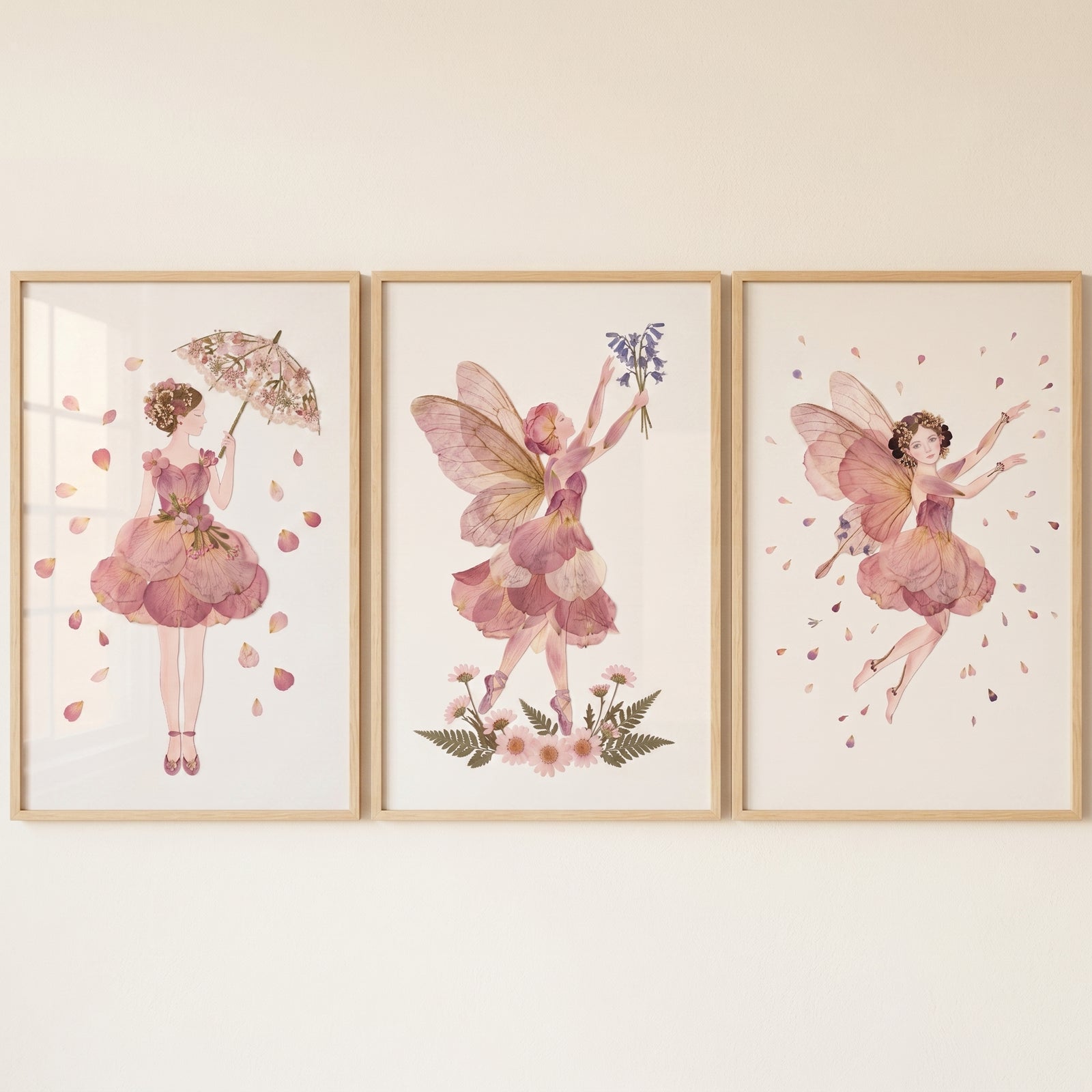 Vintage botanical flower fairy wall art set of 3 features whimsical winged figures wearing soft pink floral petal dresses.
