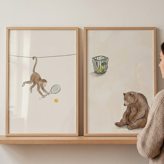 Vintage brown tennis animal wall art set of 2 with a monkey swinging a racket and a brown bear sitting by a ball basket.