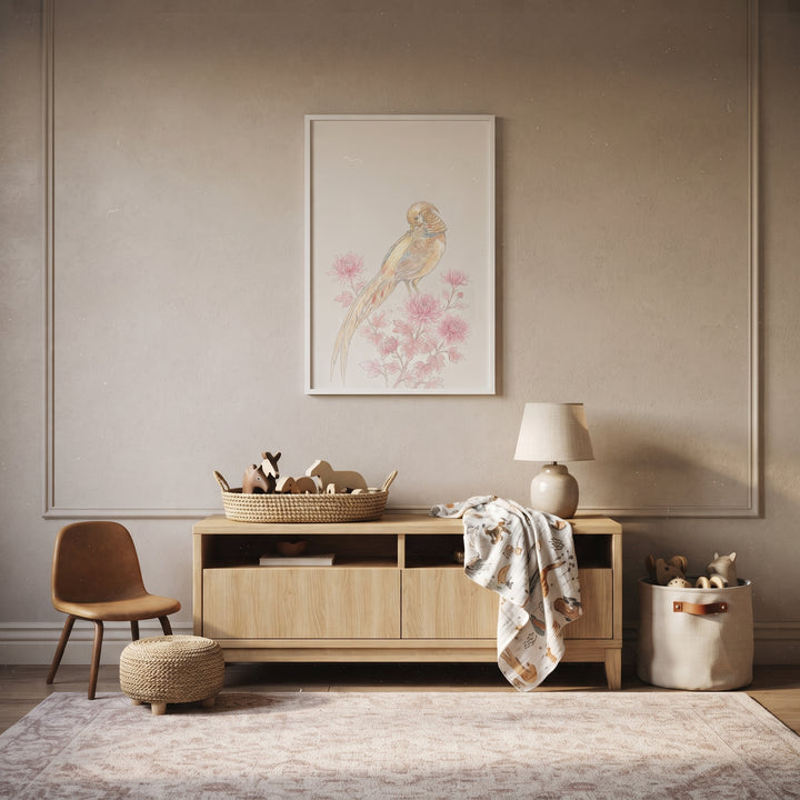 Neutral room with vintage chinoiserie pink pheasant wall art above a light wood console, small chair, and toy basket.