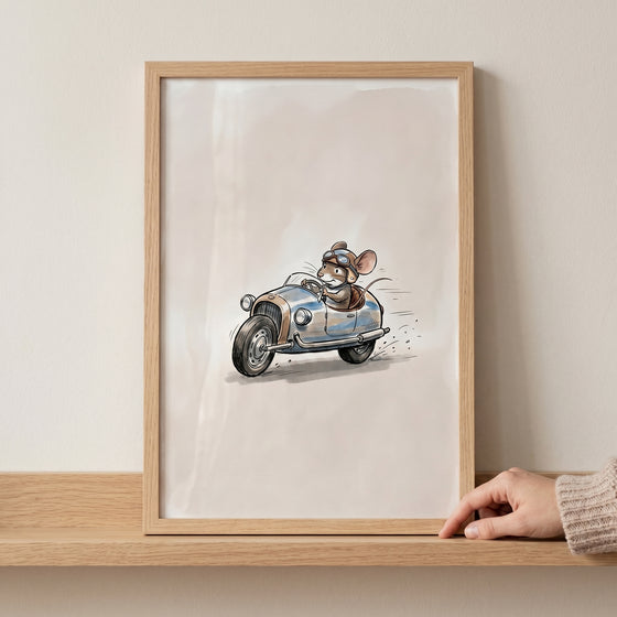 Framed vintage goggles racing mouse wall art showing a cute mouse driving a small blue classic car at high speed.