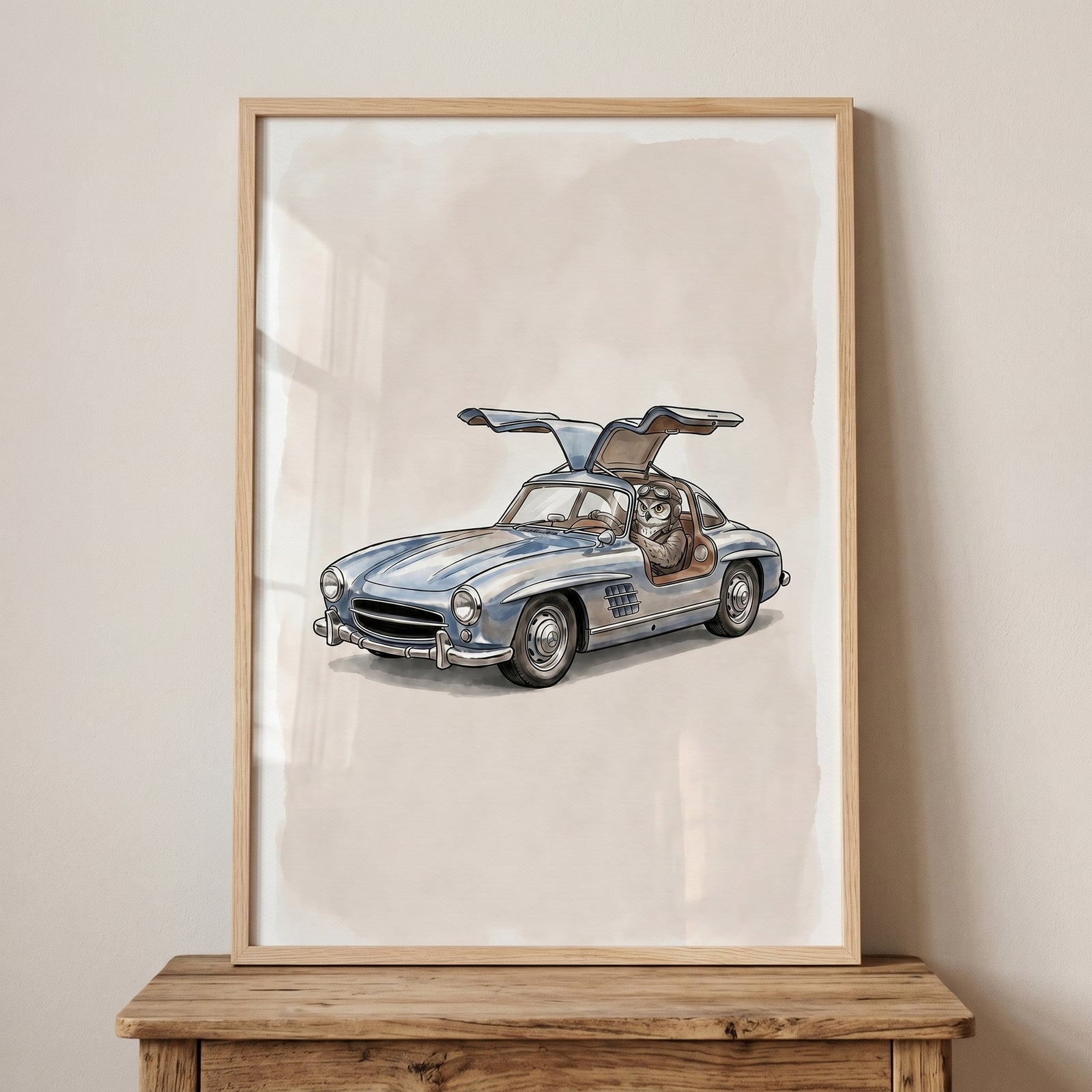 Framed vintage gullwing car owl wall art showing an owl with goggles driving a blue classic vehicle with open doors.