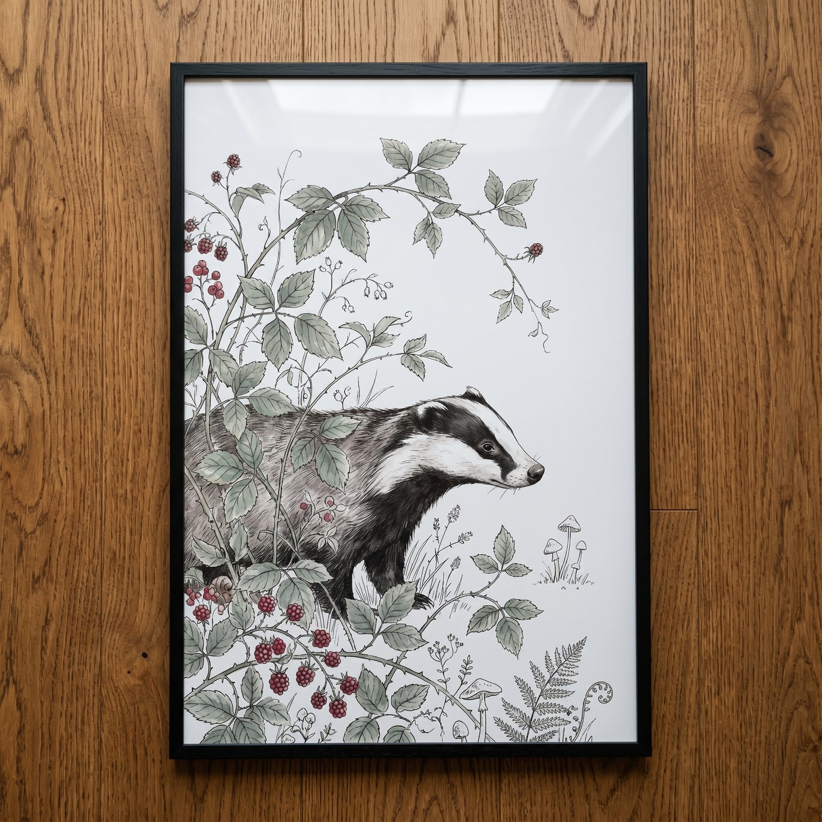 Vintage ink blackberry badger artwork in a black frame, featuring a badger among brambles, ferns, and mushrooms.
