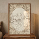 A sepia-toned line drawing of two rabbits by a pond is showcased in a dark wood frame. The central oval scene depicts the animals at the water's edge with their reflections clearly visible in the gentle ripples. The surrounding border is filled with an intricate pattern of roses and thistles. The framed artwork sits on a wooden bedside table against a neutral, textured background, creating a calm and vintage aesthetic. This illustration features a classic and nature-inspired design.