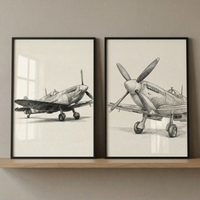 Two black-framed sketches of vintage fighter planes sit side-by-side on a light wood shelf against a neutral wall. The left artwork features a detailed, three-quarter view of a classic propeller aircraft on the ground. The right artwork shows a more direct, frontal view of a similar plane, emphasizing its prominent nose and four-blade propeller. Both illustrations are rendered in a realistic, pencil-drawn style with fine shading on light-colored paper.