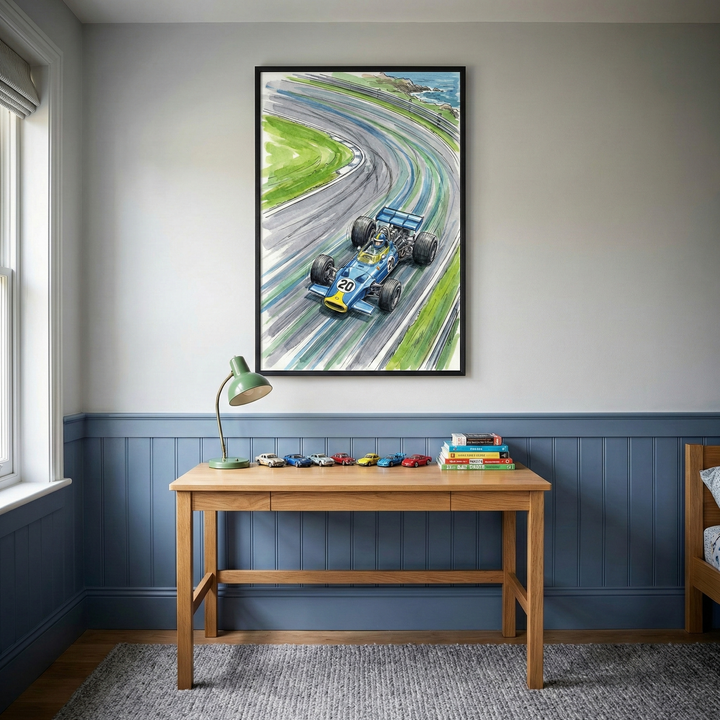 A cozy room features a wooden desk with a green lamp, several toy cars, and a stack of books. Above the desk, a vibrant painting of a blue race car speeding around a track is prominently displayed. The room has blue wainscoting and a soft carpet, creating a warm, inviting atmosphere.