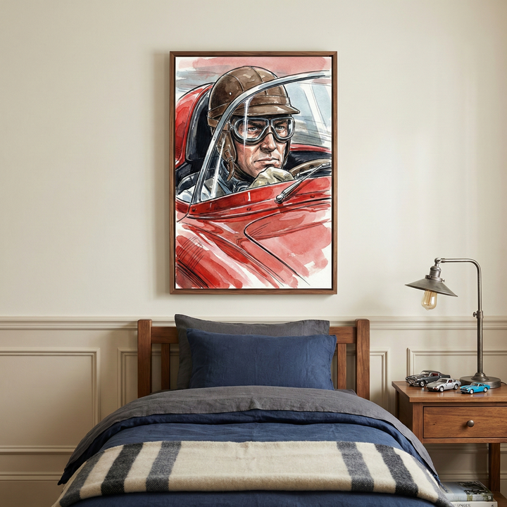 A cozy bedroom features a framed painting of a race car driver in a red car, wearing goggles and a helmet. The bed is neatly made with blue and gray bedding, and a striped blanket. A wooden nightstand holds a vintage-style lamp and model cars.