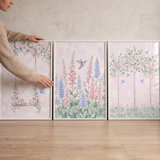 Vintage style pink garden wall art set of 3 featuring pastel flowers, a swing, and a hummingbird in white frames.