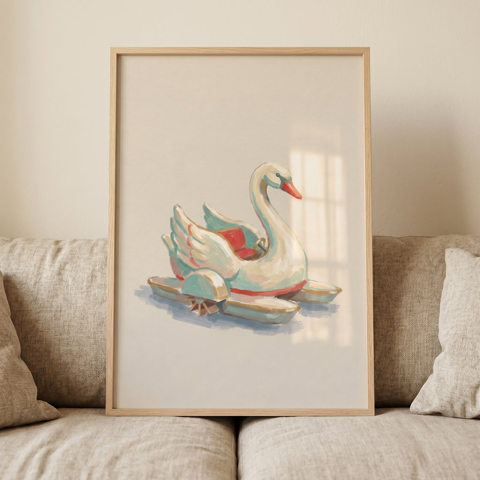 Vintage teal swan ride wall art in a light wood frame leaning on a neutral linen couch.