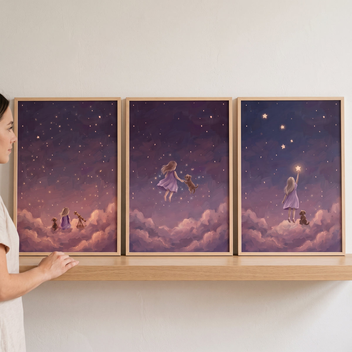Violet clouds girl dog wall art set of 3 on a wooden shelf, showing a child and puppy in a whimsical, starry night sky.