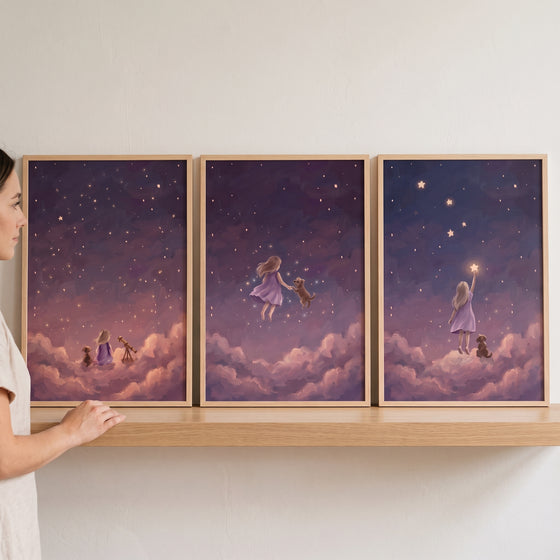 Violet clouds girl dog wall art set of 3 on a wooden shelf, showing a child and puppy in a whimsical, starry night sky.