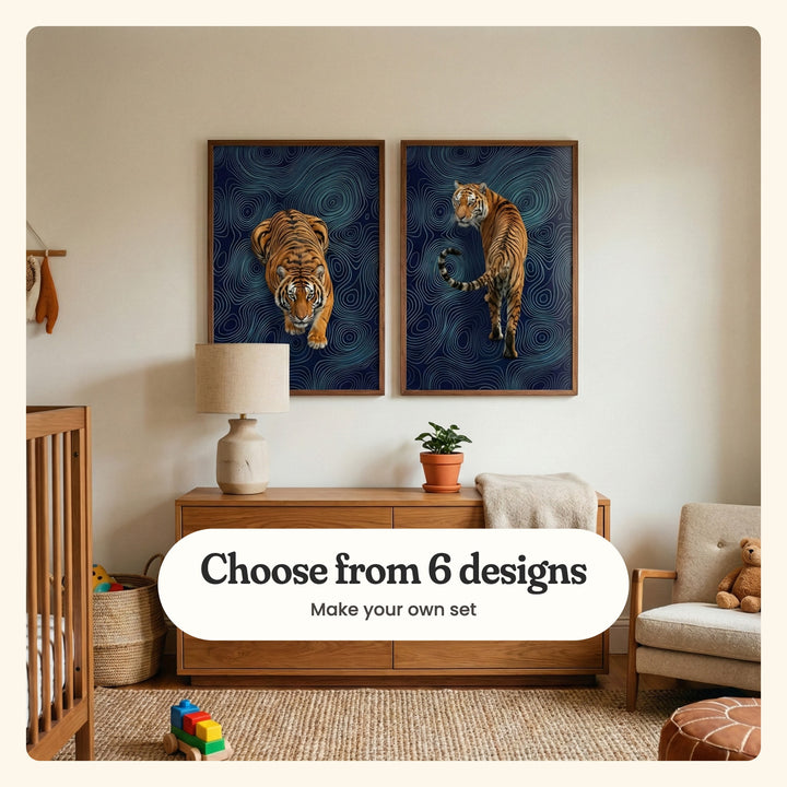 Nursery with two tiger prints in walnut frames above a walnut dresser with a linen lamp, a potted plant and a folded throw, beside a cream armchair with a teddy bear, a leather pouf and a block toy truck on a jute rug: a tiger walking toward you with its head low and a tiger looking back over its shoulder, labeled Choose from 6 designs, Make your own set