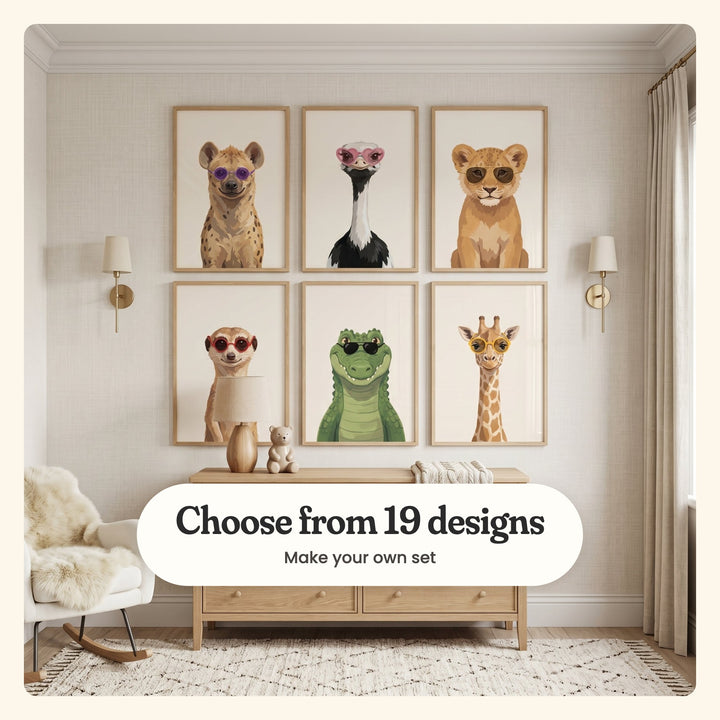 Nursery with six dapper safari animal prints in light wood frames in two rows between brass wall sconces, above a light wood dresser with a wooden lamp and a small teddy, beside a white rocking chair: a hyena in purple sunglasses, an ostrich in heart glasses, a lion cub in gold aviators, a meerkat in red glasses, a crocodile in black sunglasses and a giraffe in yellow glasses, labeled Choose from 19 designs, Make your own set