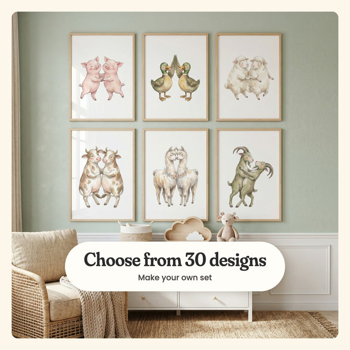 Sage green room with six animal pair prints in light wood frames in two rows above a white dresser with a cloud shelf and a teddy bear, beside a rattan armchair: Joyful Piggy Pair, Happy Duck Duo, Dancing Fluffy Lambs, Sweet Moo Mates, Llama Love and Whimsical Goat Waltz, labeled Choose from 30 designs, Make your own set